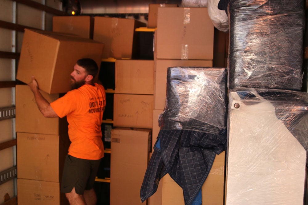 One MechaMovers employee carrying boxes
